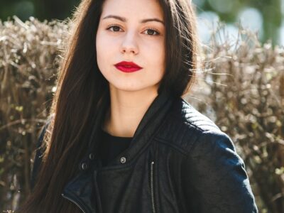 young-beautiful-girl-posing-black-leather-jacket-park_1153-8104